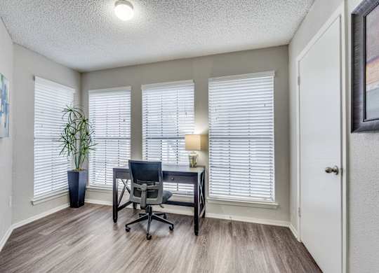 A room with a desk and a chair.