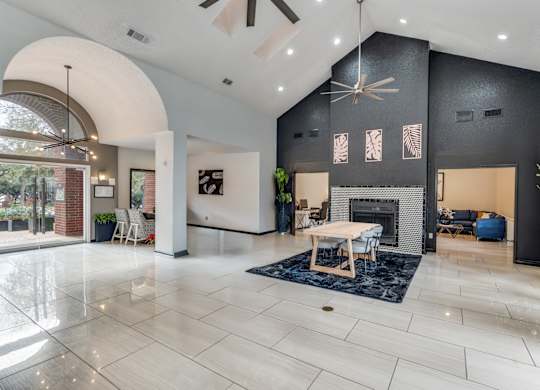 A modern living room with a fireplace and a dining table.