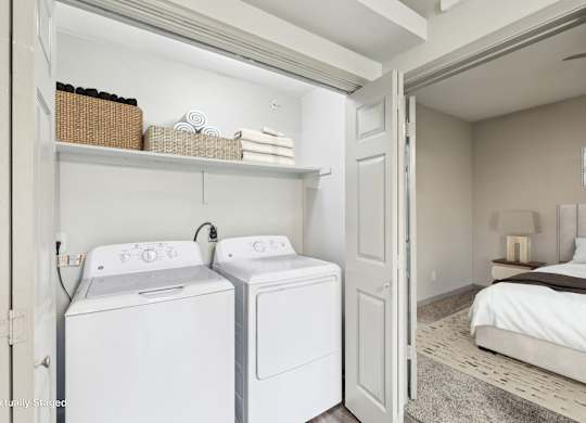 A small laundry room with a washer and dryer.