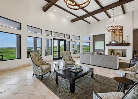 A living room with a couch, chairs, and a coffee table.