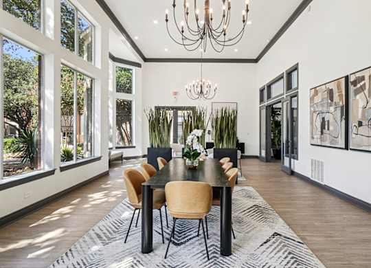 A dining room with a table set for six with chairs around it.