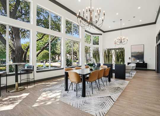 A modern dining room with a large table and chairs.