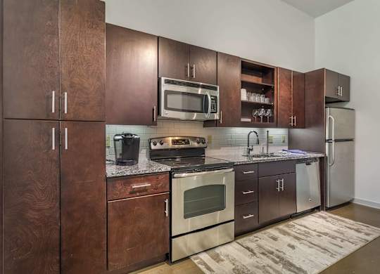 12 South Apartments - Nashville TN - kitchen with dark wood cabinets and stainless steel appliances