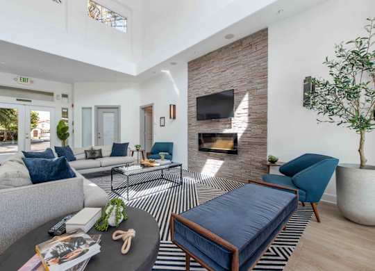 A living room with a fireplace and a blue sofa.