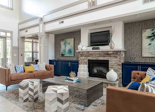 A living room with a fireplace and a television on the wall.