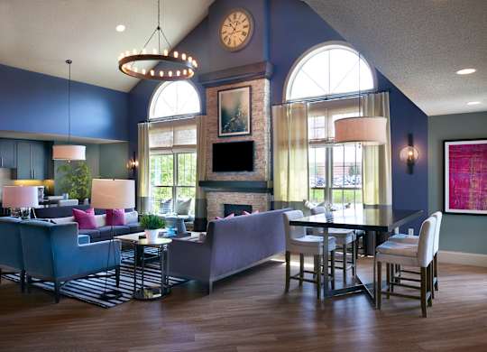 A modern living room with a fireplace and a dining table.
