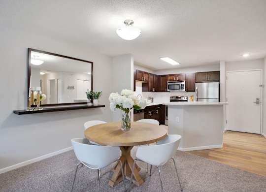 a kitchen and dining room with a table and chairs
