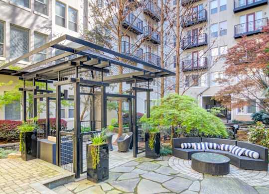 Atlanta, GA Apartments - Biltmore at Midtown - Beautiful Courtyard with Trees and areas to relax