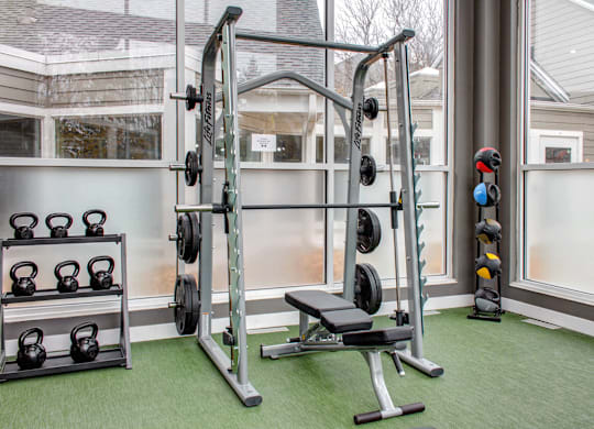 Free weights in fitness center, smith machine