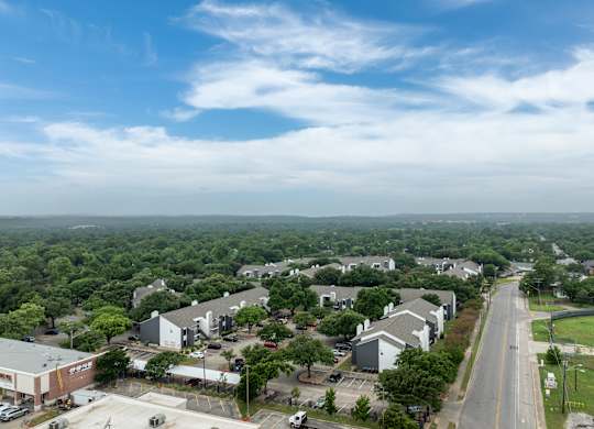 an aerial view of a neighborhood with houses and trees