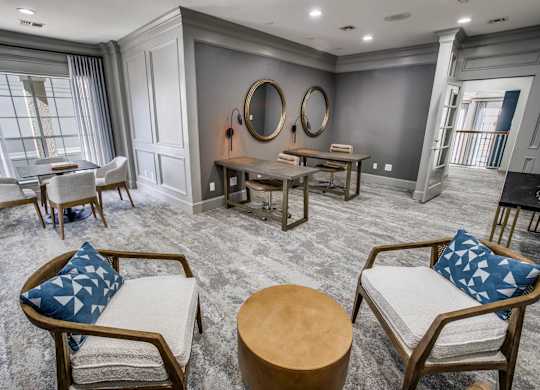 A living room with a grey carpet and wooden furniture.
