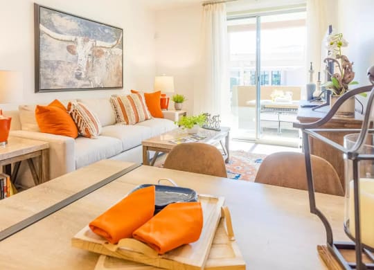 a living room with couches and a table with oranges on it