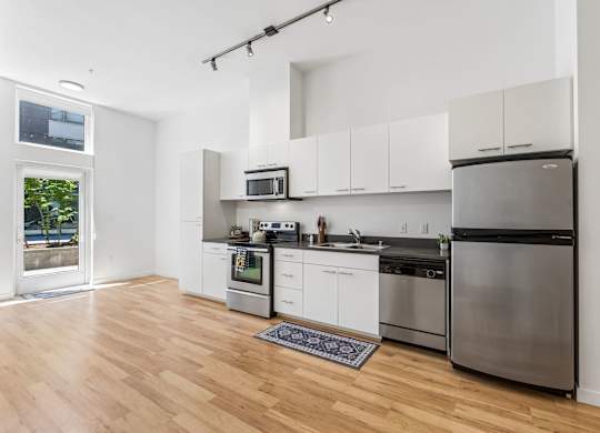A kitchen with white cabinets and stainless steel appliances.