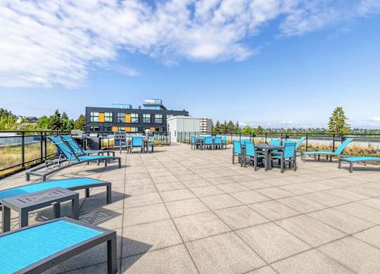 Apartments In Green, Lake Seattle, WA, for Rent - Circa Green Lake - BBQ Area With Lounge Seats, Tables And Chairs, And Expansive Views.