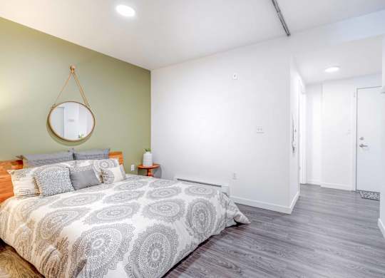 a bedroom with a bed and a mirror