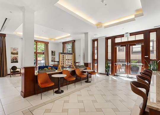 the lobby of a hotel with a reception desk and chairs