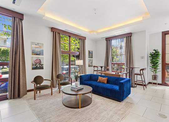 a living room with a blue couch and a table