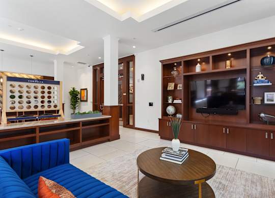 a living room with a blue couch and a television