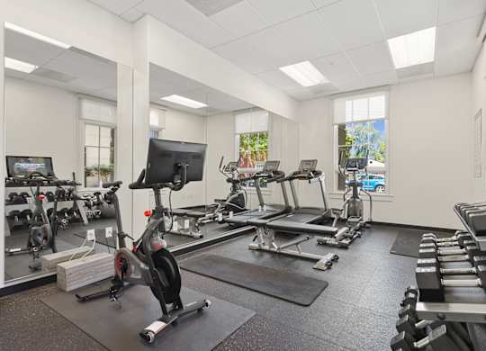 the gym with treadmills and other exercise equipment at the belgard apartments
