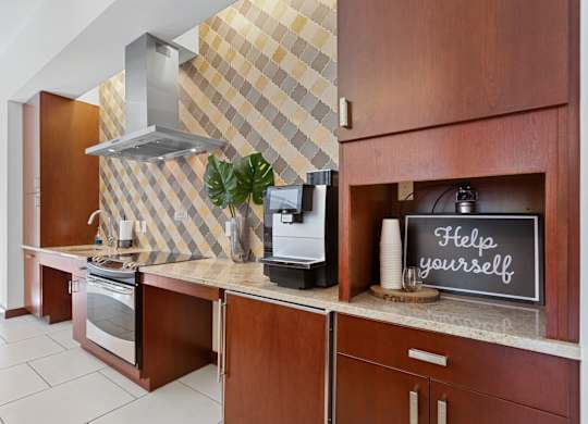 a kitchen with a counter with a sign that says help yourself