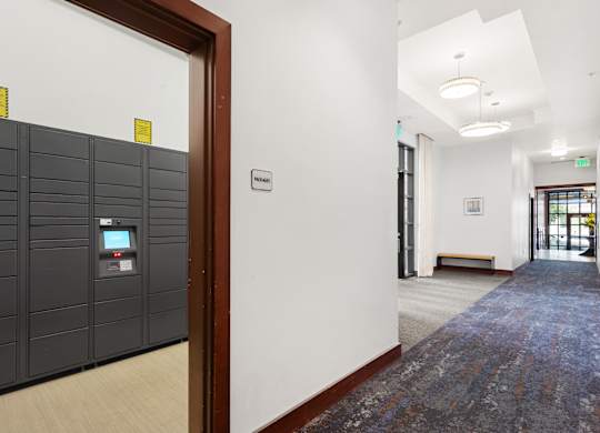 a view of a hallway with a row of lockers and a door