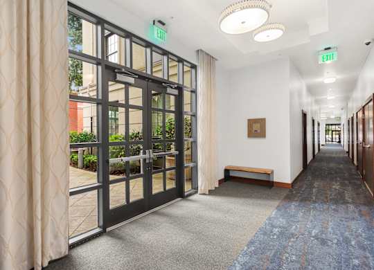 a hallway with doors and windows in a building