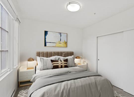 a bedroom with a bed and a large window