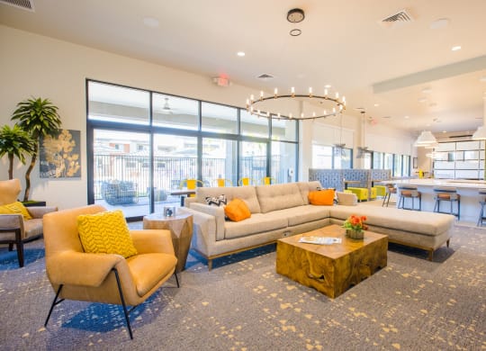 a living room with couches and chairs and a table