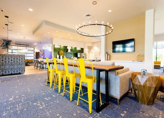 a dining room with yellow chairs and a table