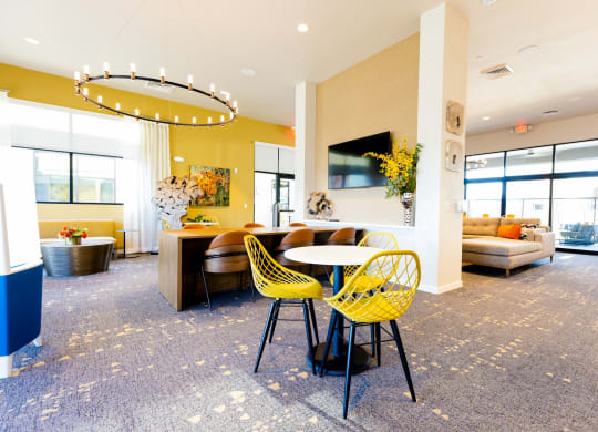 a room with a table and chairs and a couch