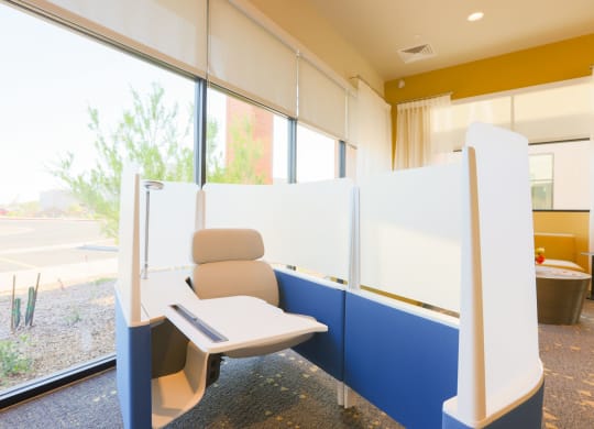 a public seating area with a chair and a window