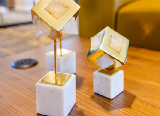 a group of geometric statues on a table in a living room
