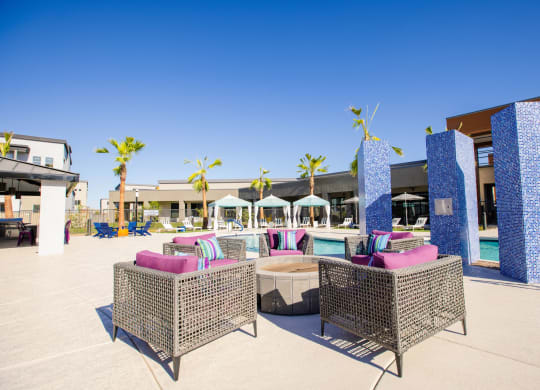 a lounge area with chairs and a pool at a resort