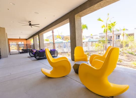 furnished lobby with yellow chairs and a view of palm trees