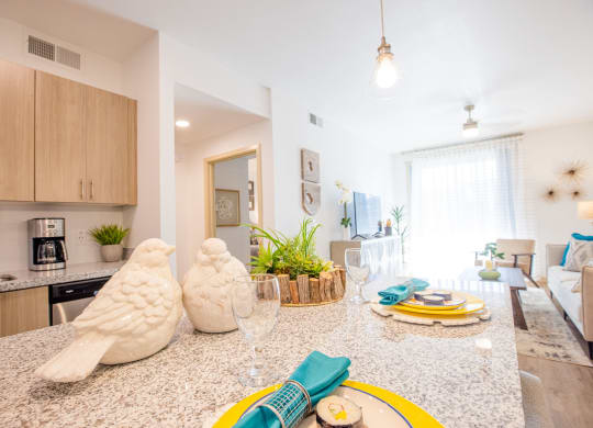 a kitchen and living room with a counter top and a table