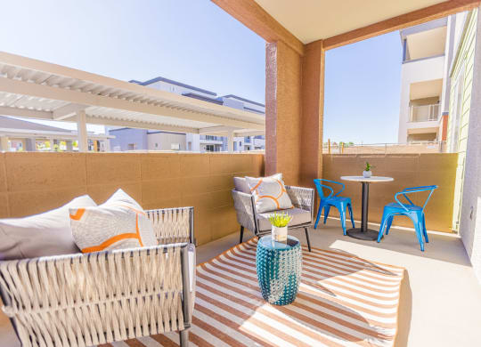 a patio with a table and chairs and a couch