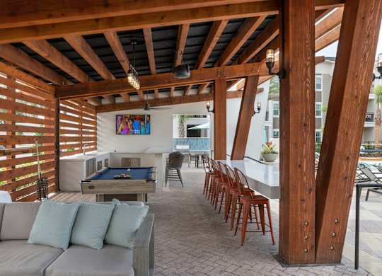 Apartments In Riverview, FL for Rent – Sole at Brandon – Poolside Grill, Pool Table and Lounge Area