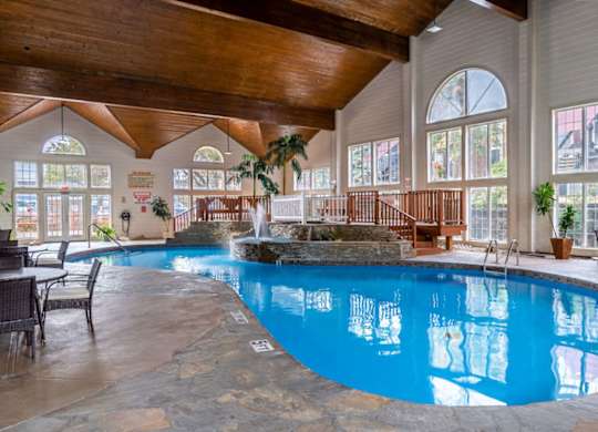 a large swimming pool in a building with large windows