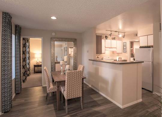 a dining room and kitchen with a table and chairs