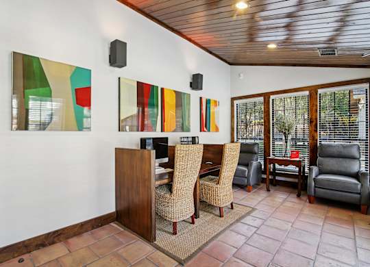 A room with a wooden bar and chairs.