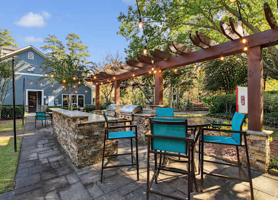 A patio with a table and chairs under a pergola.