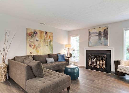 Glen Lake Apartments in Atlanta, GA 30328 photo of a living room with hardwood floors and a fireplace