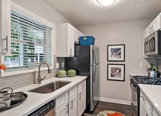 Glen Lake Apartments in Atlanta, GA 30328 photo of a kitchen with white cabinets