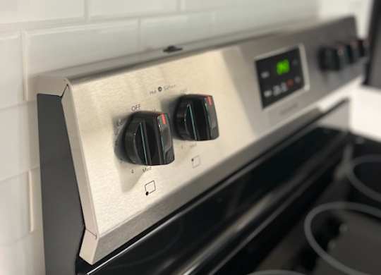a stove top oven sitting inside of a kitchen