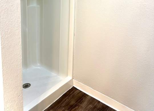 a bathroom with a shower and a towel rack