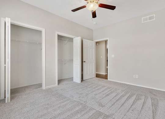 Luxury One Bedroom Apartments in Plano, TX - Carrington Park Apartments Bedroom With Ceiling Fan, Plush Carpeting and Large Closets