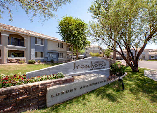 Apartments in North Phoenix AZ - Ironhorse at Tramonto - Building Exterior with Entry Sign, Landscaping and Street View