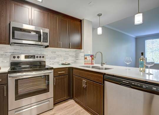 Apartments for Rent in Walnut Creek, CA- Ivy Hill- Kitchen with Stainless-Steel Appliances, Wood-Style Cabinetry, and Quartz Countertops