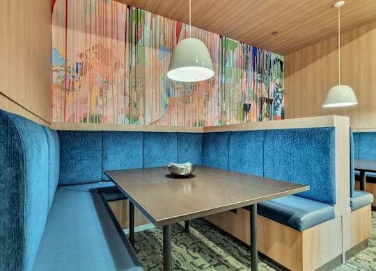 a dining room with blue chairs and a wooden table