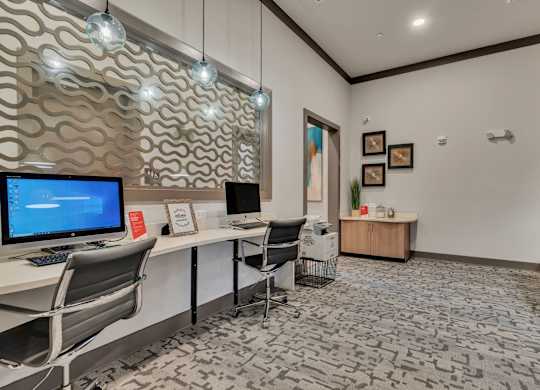 a conference room with a desktop computer on a desk